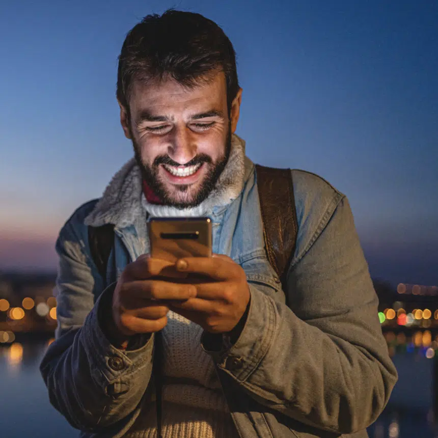 man smiling challenges on phone